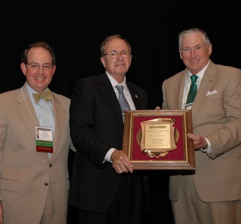 Chief Judge John C. Martin, center, accepts the NCBA’s John J. Parker Award in 2013 from President Mike Wells, right, and Immediate Past President Martin Brinkley.