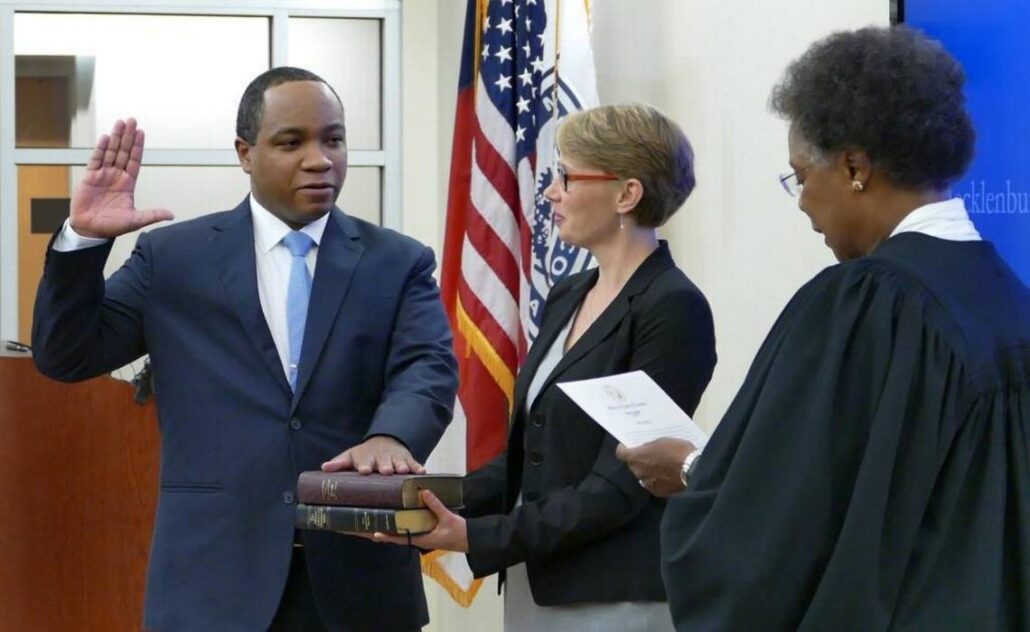 Judge Yvonne Mims Evans administers the oath of office to District Attorney Spencer Merriweather as his wife, Lila, holds the Bible. (Photo courtesy of The Charlotte Observer).
