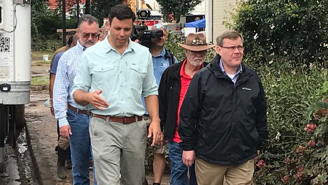 Zeb Smathers, left, leads House Speaker Tim Moore, right, and area lawmakers on a tour of storm-damaged areas of Haywood County on August 20.