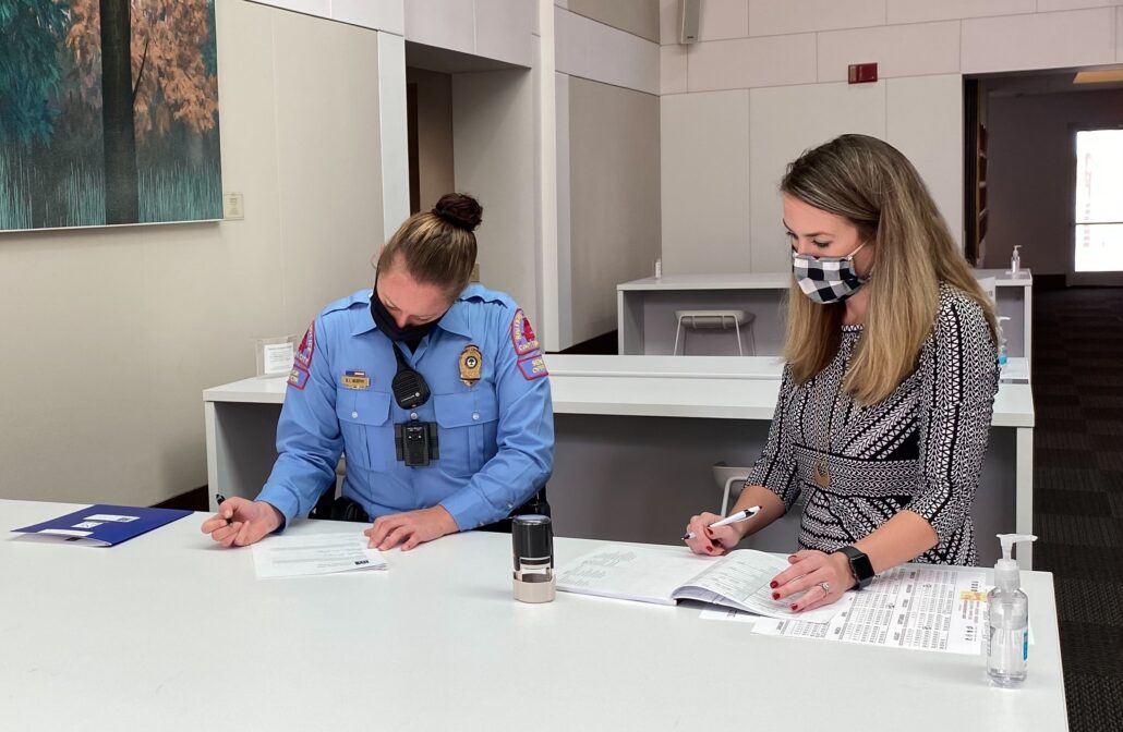 NCBF Pro Bono Clinics Attorney Alex Rogers, right, assists an officer during a recent Wills for Heroes clinic.