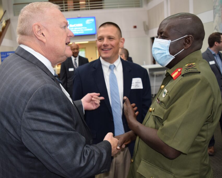 Kirk Warner speaks with Professor John Brooker (UNC School of Law) and Brig. Gen. Godard Busingye of Uganda.