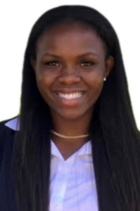 Tierica, a Black woman with black hair, wears a white shirt and black jacket.